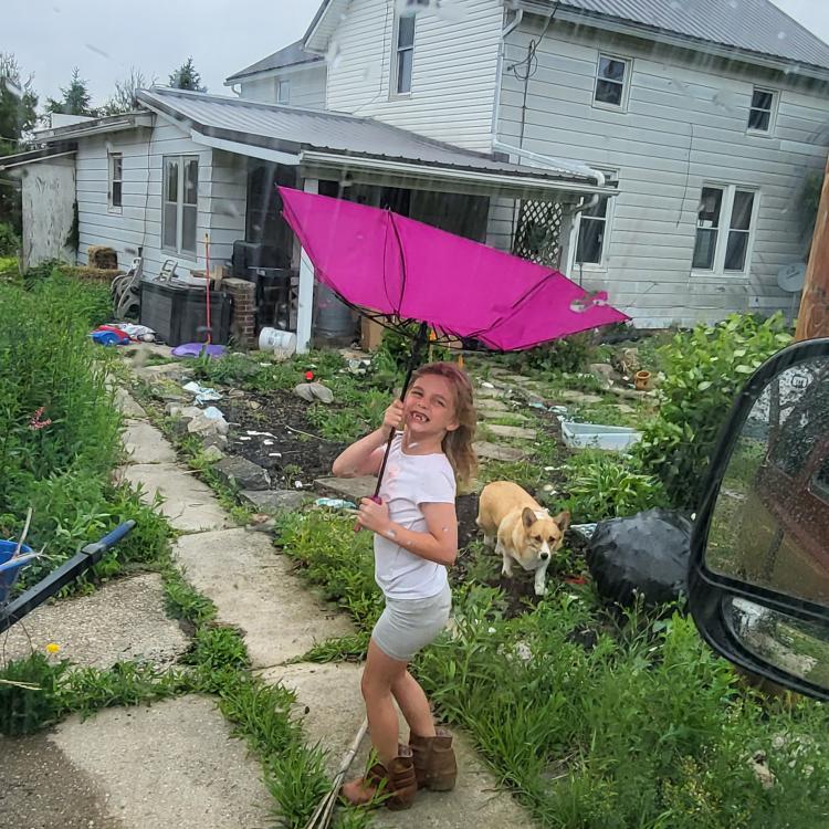 little girl with umbrella blown inside-out