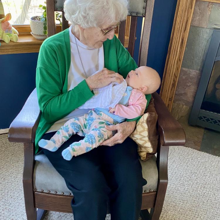 woman on rocking chair with tiny baby