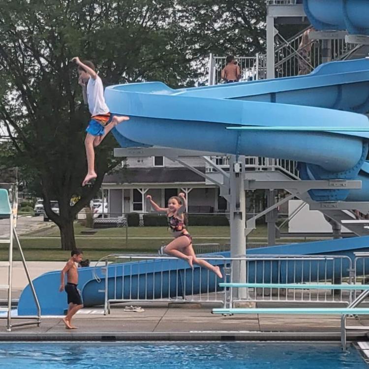 boy and girl jumping off diving boards