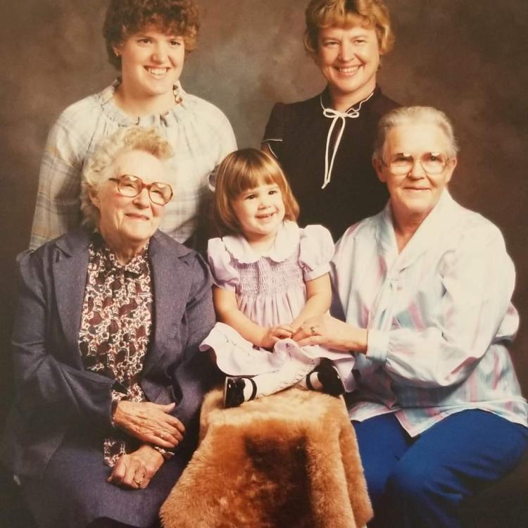 several generations of women/girls in studio photo