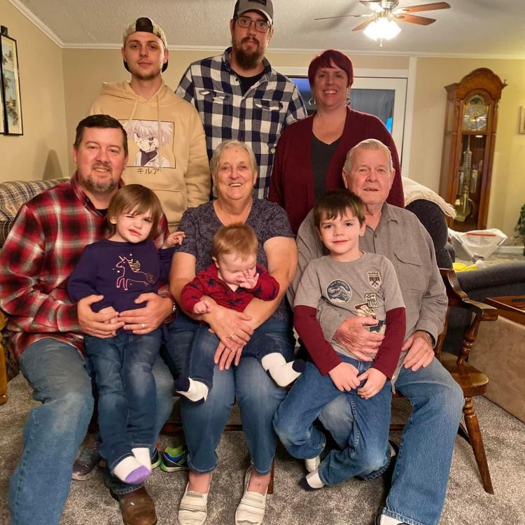 Adults and children pose in living room