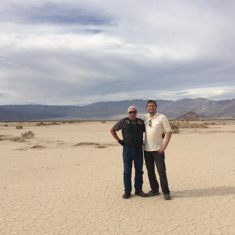 two men standing in desert