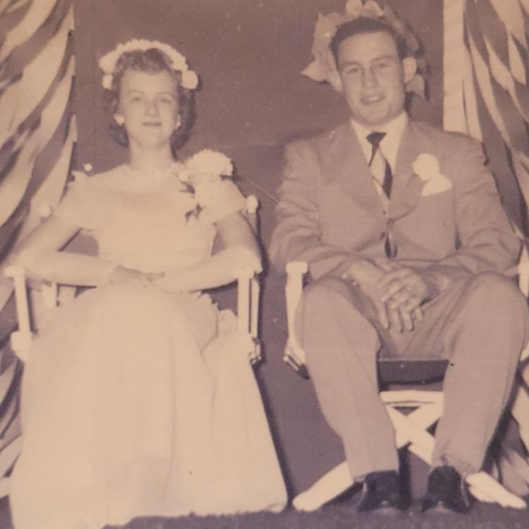 sepia photo of young man and young woman, dressed up