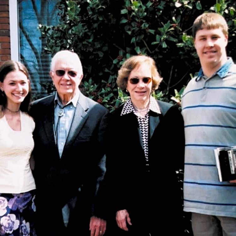 four people standing outside