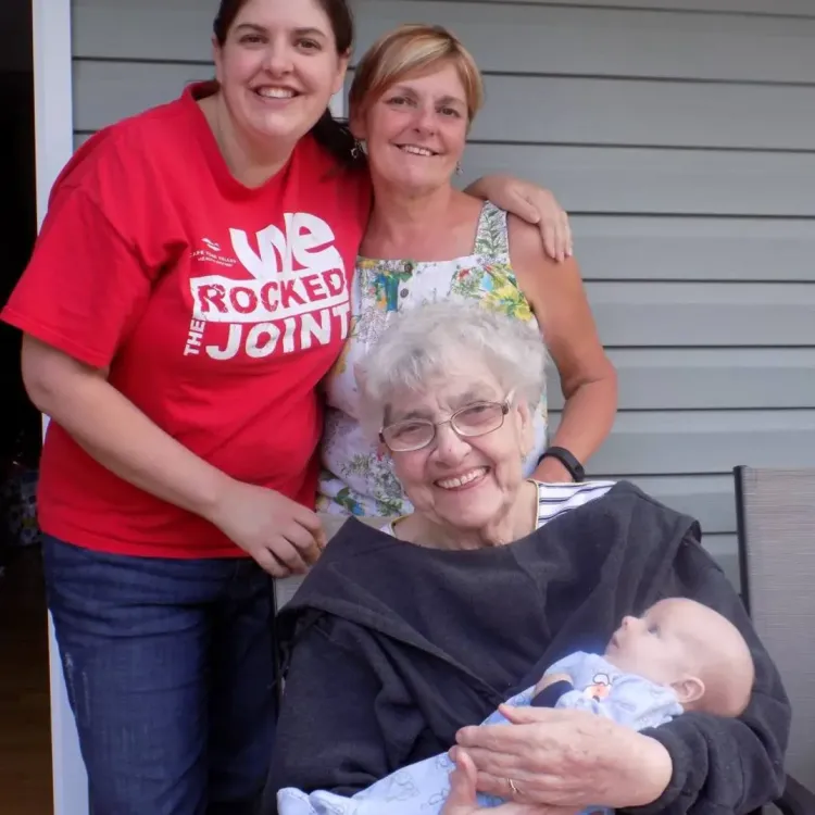 three women and a baby on a porch