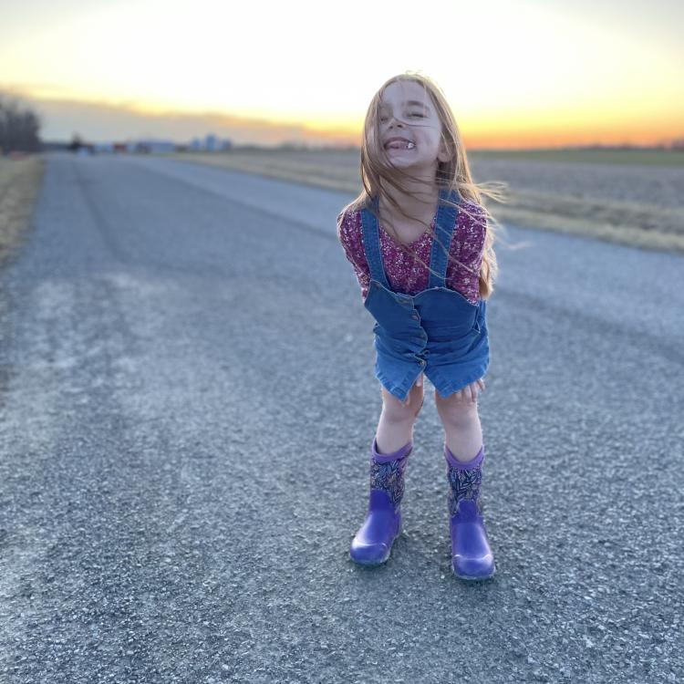 little girl with hair blowing over her face