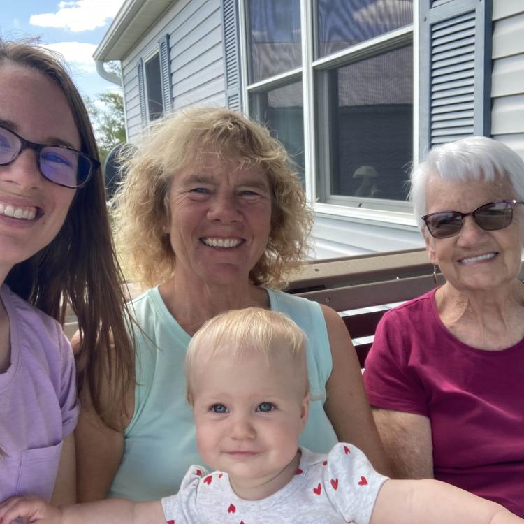 three women and a baby outside