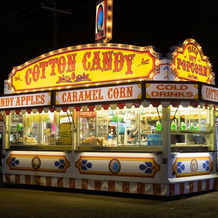 fair food stand advertising cotton candy, caramel corn, etc.