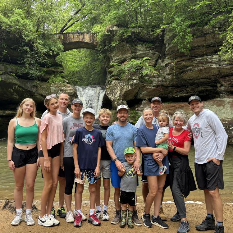 group of people in front of waterfall