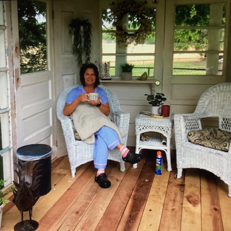 woman in chair with coffee cup