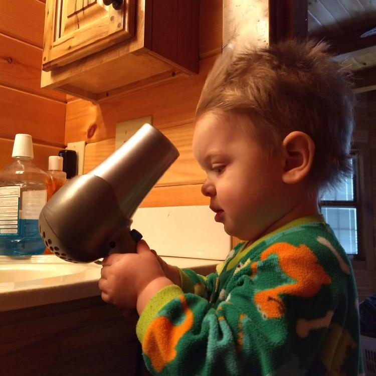 small child with blow dryer