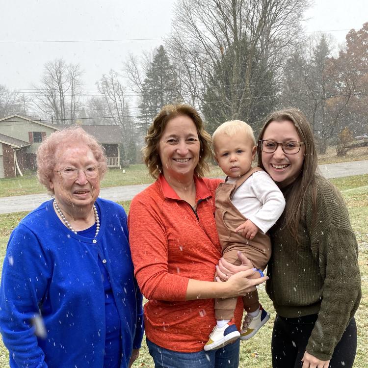 three women and a baby outside