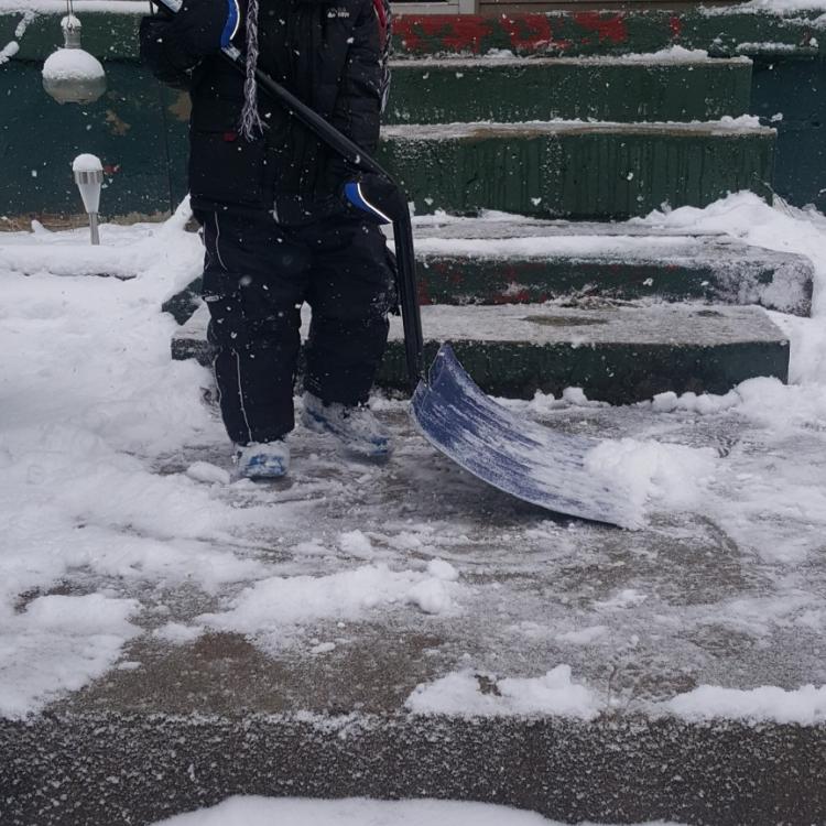 boy shoveling snow