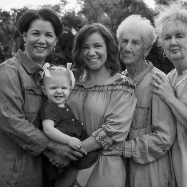 four women and a little girl outdoors