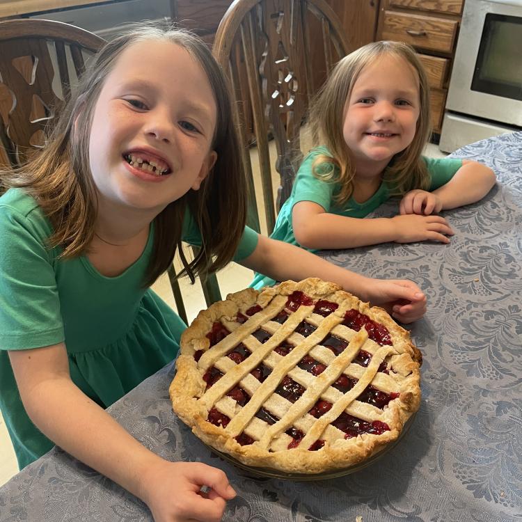 two little girls and a pie