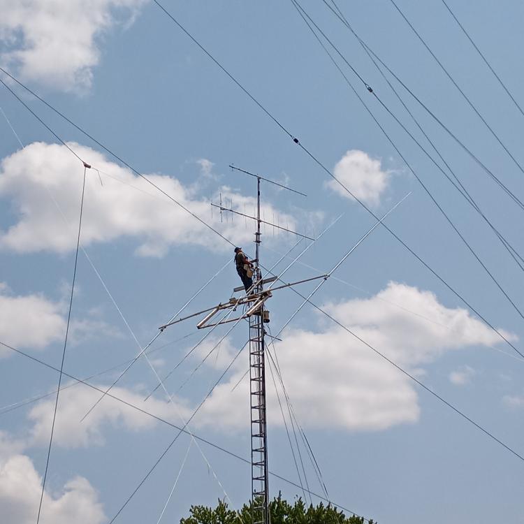man on high tower with antenna