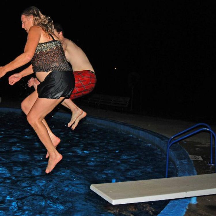 two people jump off diving board
