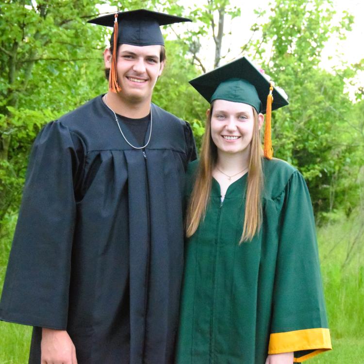 young man and young woman in caps and gowns
