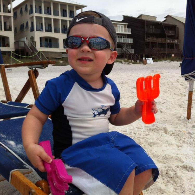 small boy on beach chair