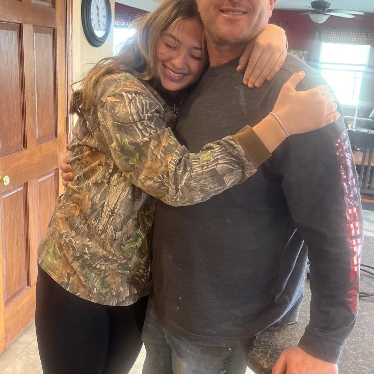 young woman hugging man