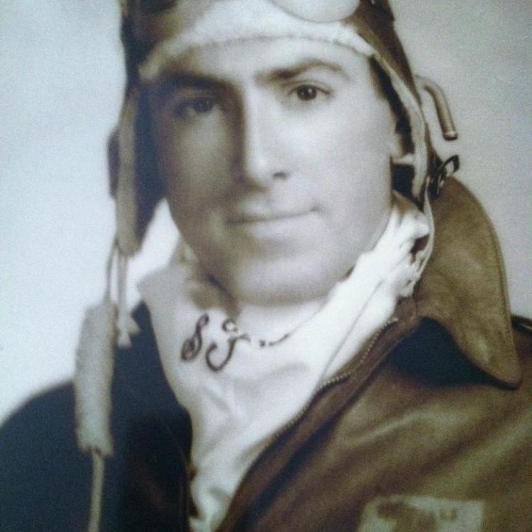 young man in pilot uniform with goggles on head