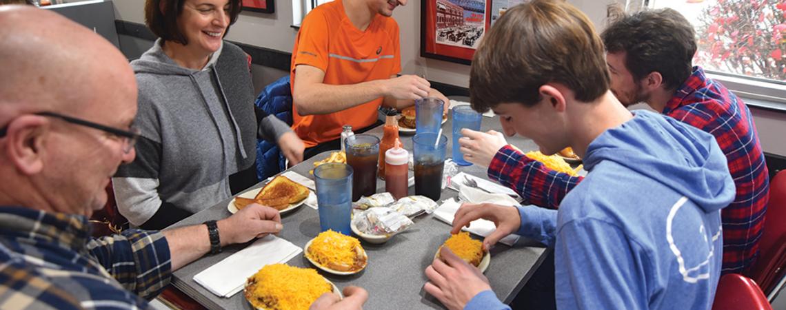 The Weirich family of Cincinnati digs in to a meal at Camp Washington Chili. (Photo by James Proffitt.)