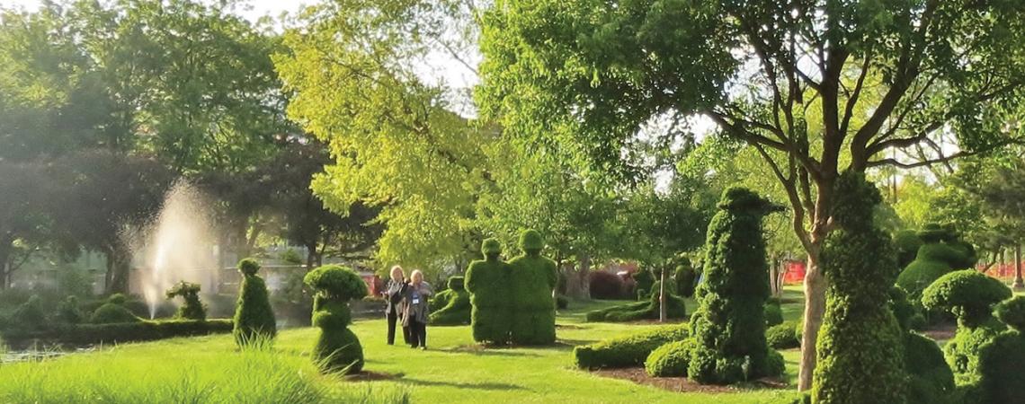 Multiple topiaries are pictured in the garden.