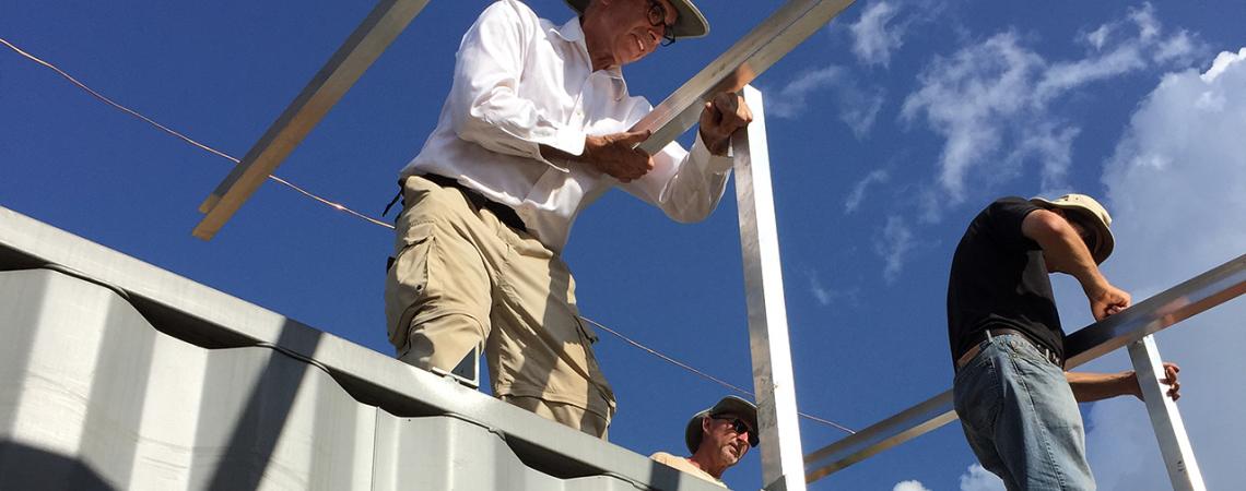 Tony Ahern, former CEO of Ohio’s Electric Cooperatives, holds a beam 