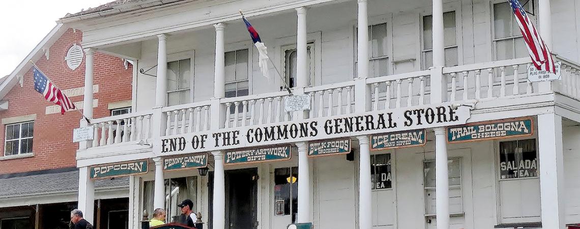 A picture of people sitting outside the End of the Commons General Store