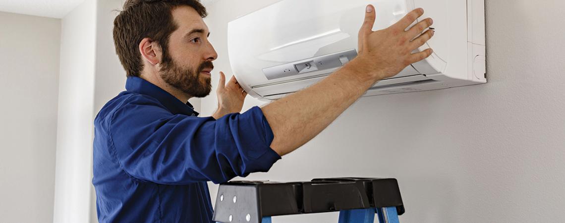 A man installs a blower.