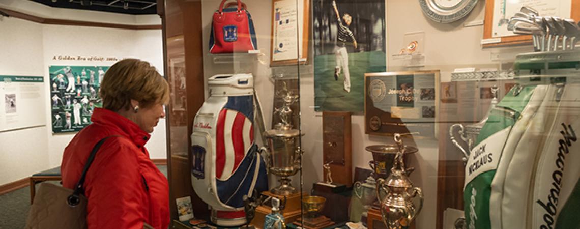 A woman examines a display at the Jack Nicklaus Museum