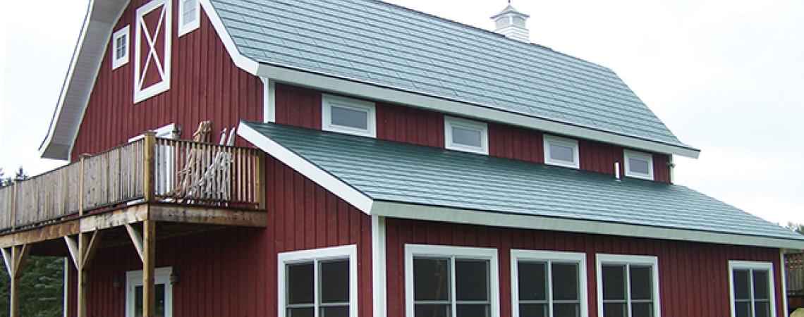 A large red barn with a metal roof.