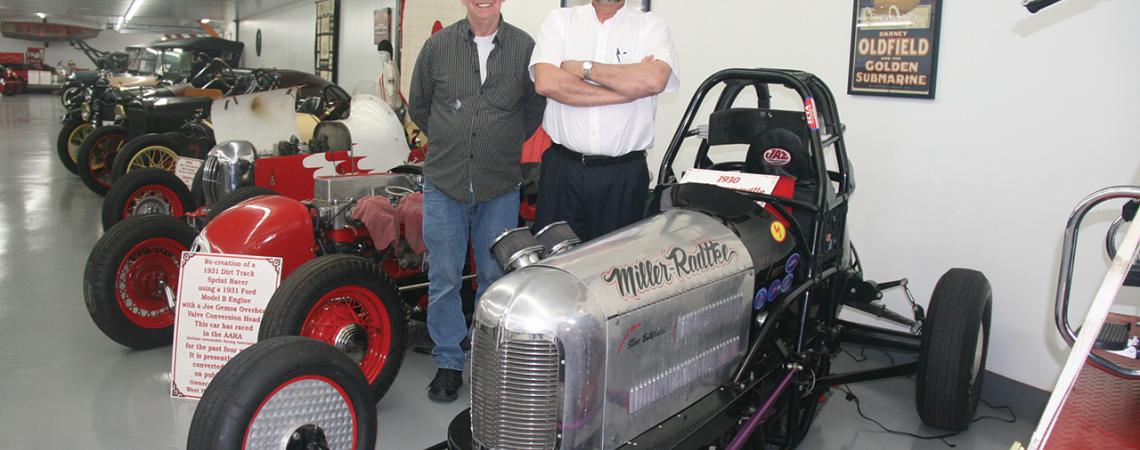 Ron Miller and Mark Radtke stand next to a Model A Ford-powered sprint car in the Salty Dog Museum.