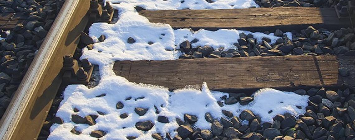 Train tracks covered in snow.