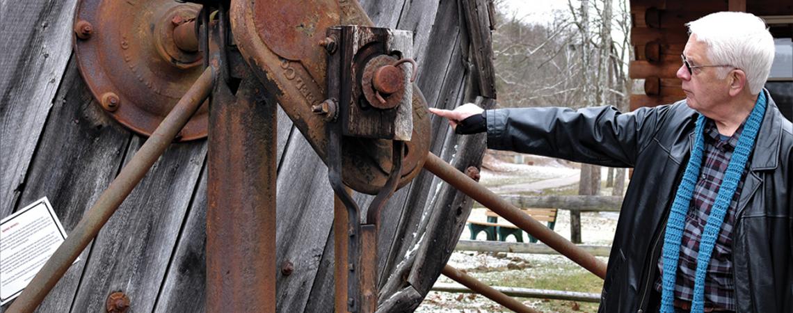 A man points to a part of the museum.