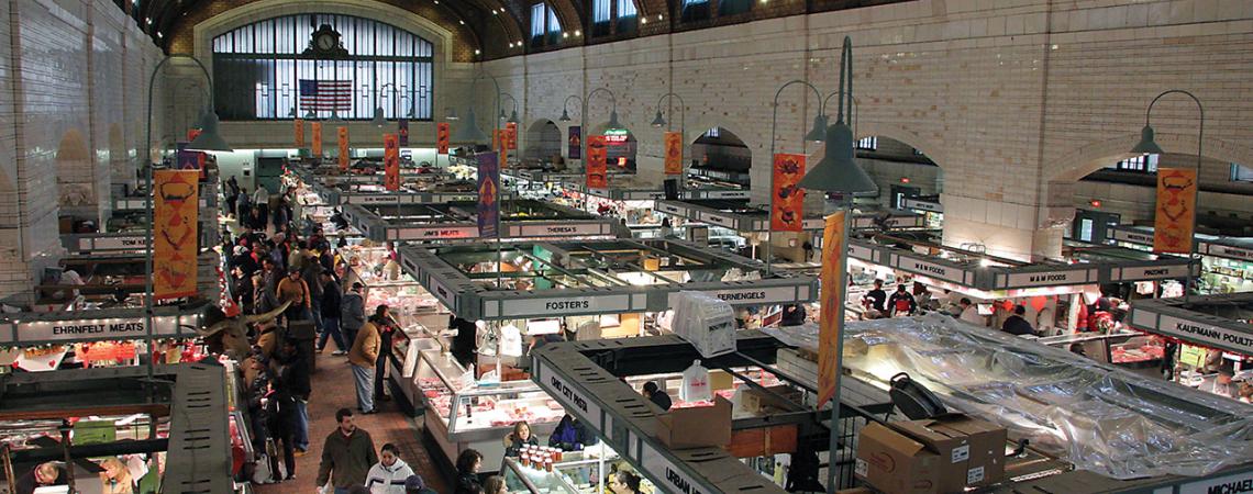 A photo of Cleveland's West Side Market from above as vendors and visitors mingle below.