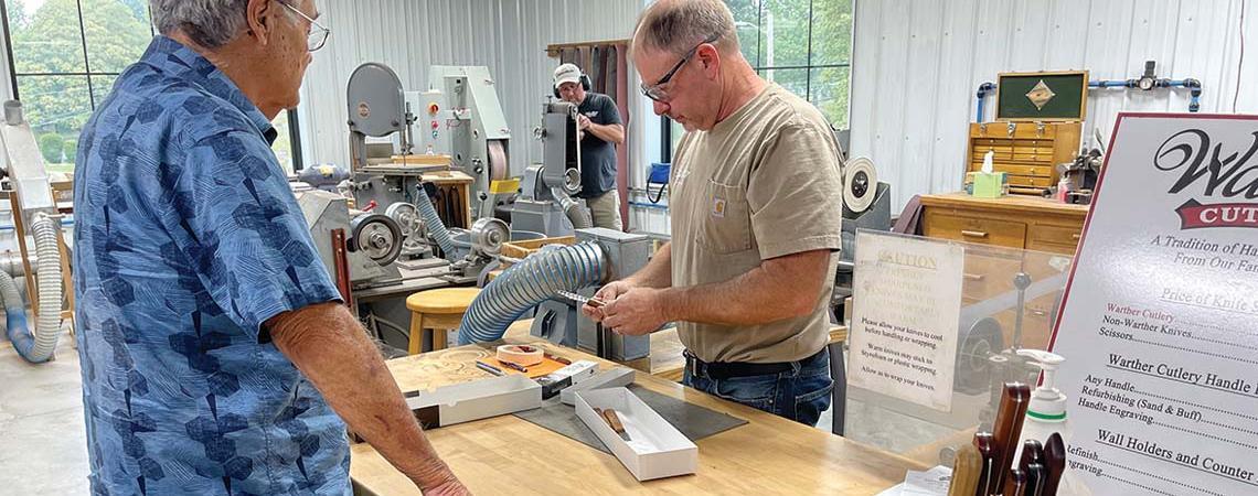 Customers watching Warther knives being made in the store. 