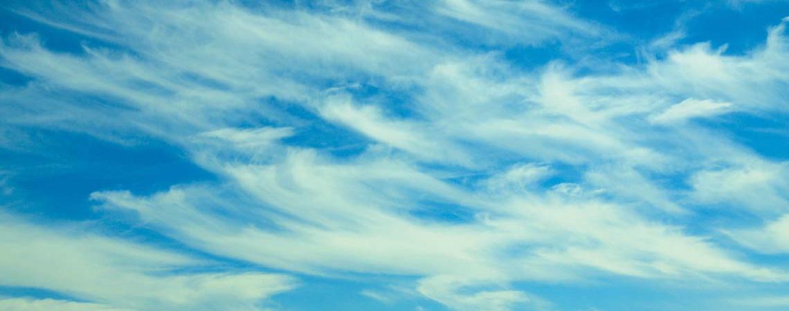 Wispy mare's tails are the advance clouds of a weather front.