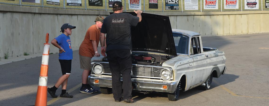 Jeff Gates pops the hood on his 1965 Ford Ranchero after it stalled on its way to the starting line.