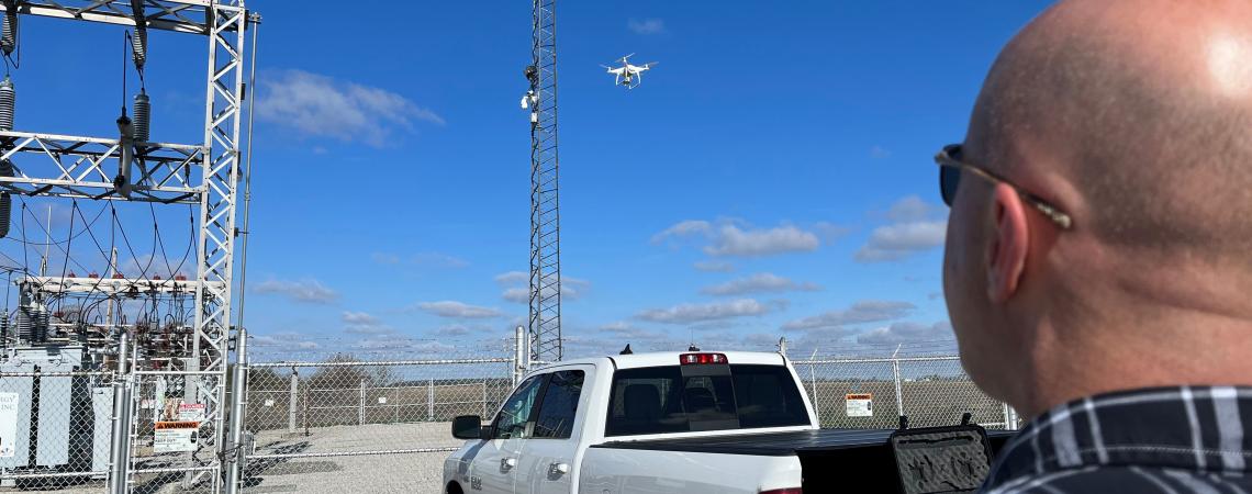 Brent Ransome of Kenton-based Mid-Ohio Energy Cooperative examines a radio tower as well as some of the components of one of the co-op’s substations using a drone. 