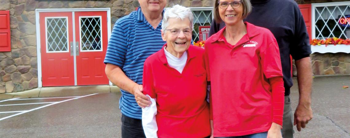 The second and third generations of the Stalder family of cheesemakers: John Stalder and Chuck Ellis stand behind Grace Stalder and Sally 