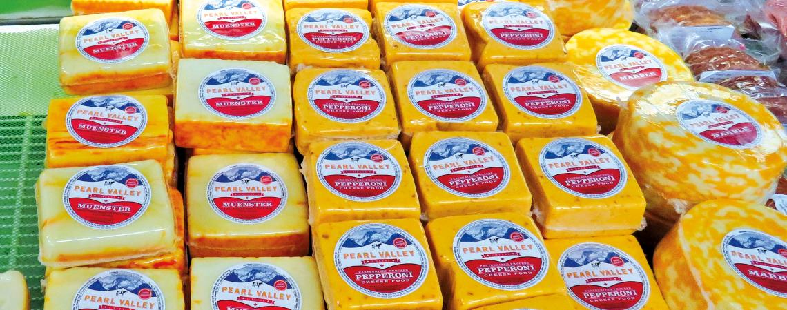 A selection of cheeses fills the Pearl Valley Cheese display case.