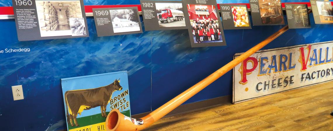 A display inside the shop shows Stalder family photos and Pearl Valley Cheese memorabilia. 