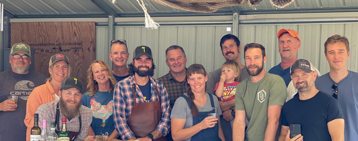 A group of students with their teachers (Andy Lane and Doug Wharton, in matching hats) after a recent workshop (photo courtesy of Hand Hewn Farm).