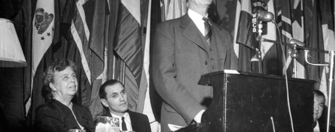 Murray Lincoln addresses an assembly gathered to hear about electrification, as Eleanor Roosevelt (left) listens intently.