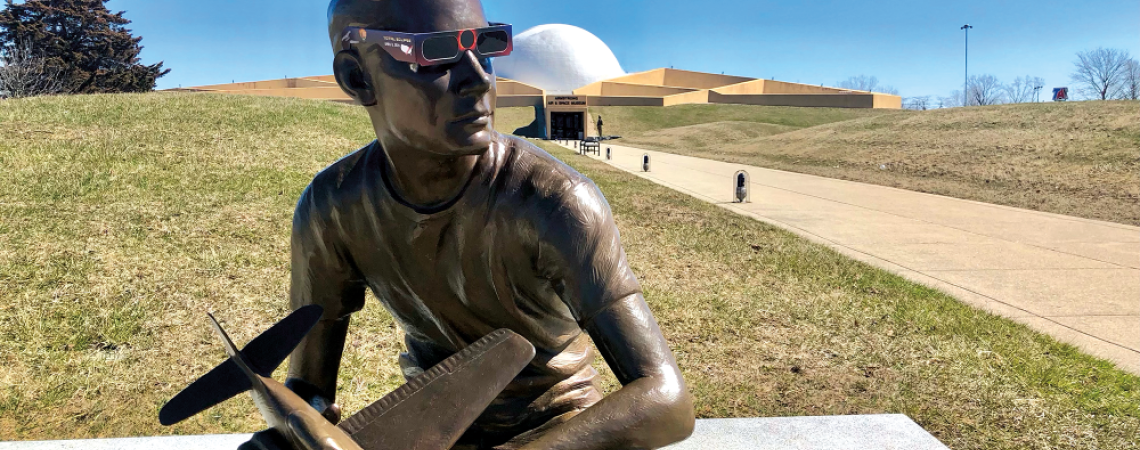 Chas Fagan’s bronze statue of 15-year-old Neil Armstrong — ready for the eclipse (photo courtesy of the Armstrong Air and Space Museum).