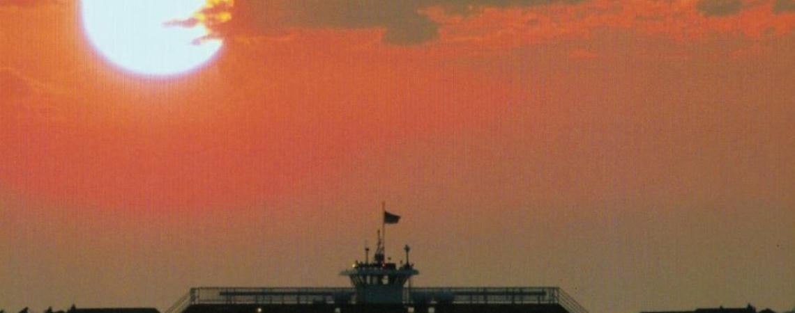 A beautiful sunset view on the lake with a ferry.