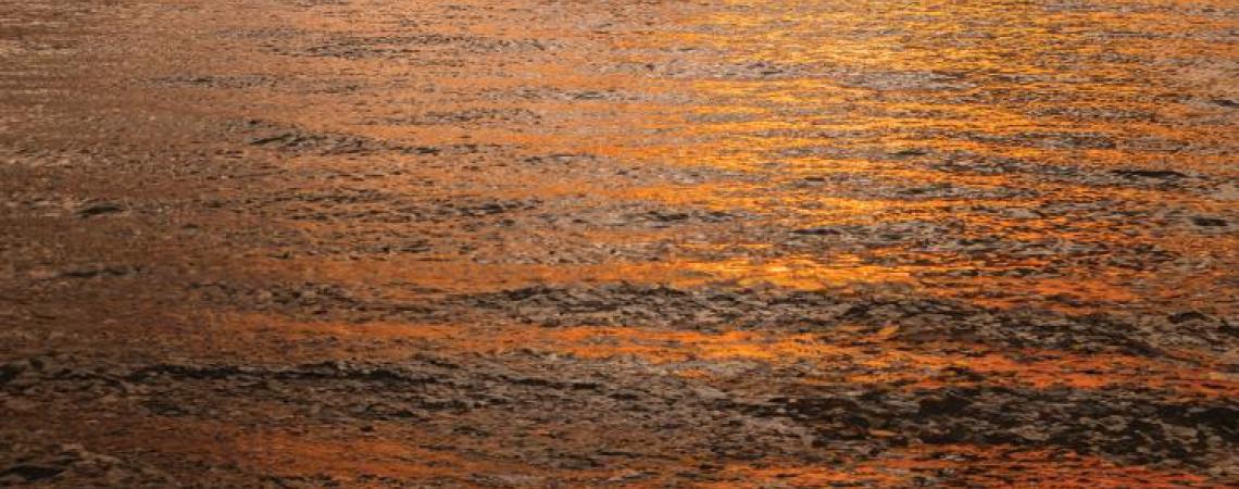 A pontoon boat overlooking a beautiful sunset on Buckeye Lake.