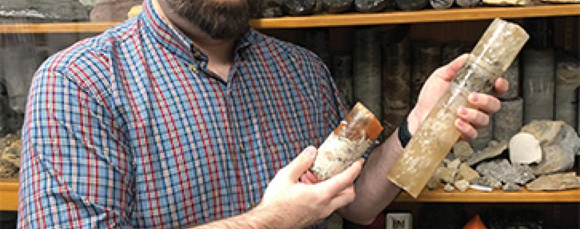 Chris Wright, geology program supervisor for the ODNR, Division of Geological Survey, displays rock core sections of an Ohio salt bed. 