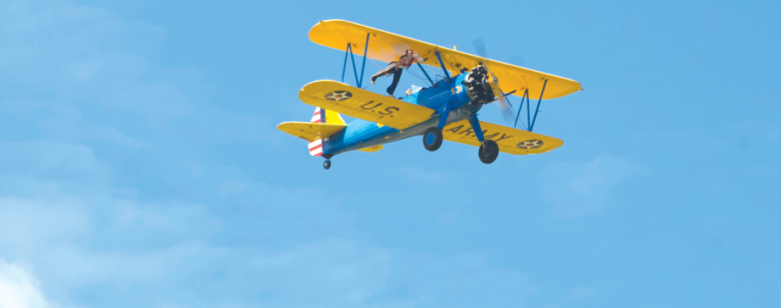 A vintage airplane flying in the sky.